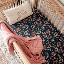 Load image into Gallery viewer, Snuggle Hunny Kids Belle Fitted Cot Sheet shown on a rattan cot bed with throw and pillow on top