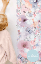 Load image into Gallery viewer, blonde girl measuring herself next to floral growth height chart wall sticker