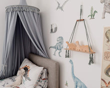 Load image into Gallery viewer, grey canopy hanging above bed in boys dinosaur themed bedroom. dinosaur wall decals and bedding