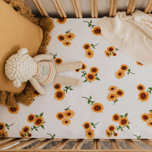 Load image into Gallery viewer, Snuggle Hunny Kids Sunflower Fitted Cot Sheet shown on a cot bed with throw , soft lamb toy and tassel cushion on top
