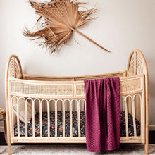 Load image into Gallery viewer, Snuggle Hunny Kids Belle Fitted Cot Sheet shown on a rattan cot bed with throw and dried leaf on wall