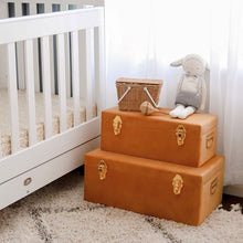 Load image into Gallery viewer, two terracotta coloured storage cases with gold clasps sitting on floor of babies nursery