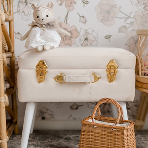 front view of bone coloured storage stool with gold handles