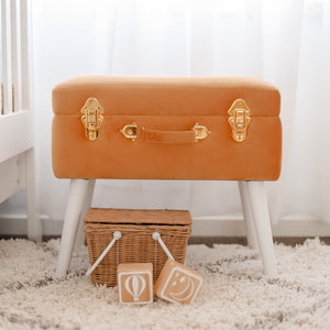 terracotta storage stool in nursery with wicker basket and wooden blocks in front on the floor