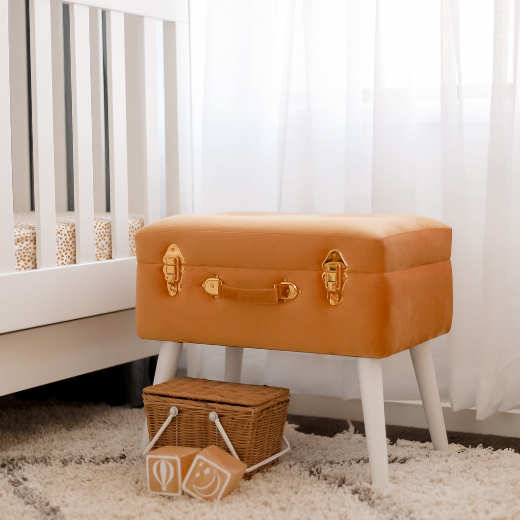 terracotta coloured stool in neutral nursery with basket and blocks