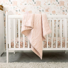 Load image into Gallery viewer, Alimrose cloud soft quilt in petal pink displayed on white cot with flower wallpaper in background