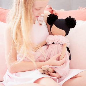 Valentina Pom Pom Doll - Sparkle Pink - 48cm being held by a young girl with cushions behind her