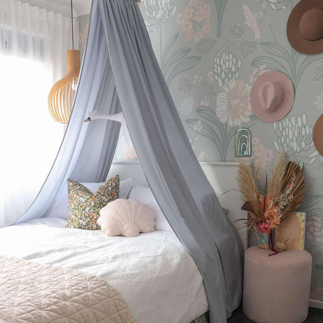 light grey canopy hanging over double bed in girls bedroom