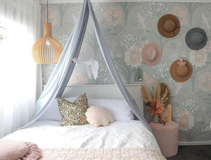 double bed in girls room with grey drape canopy hanging above bed