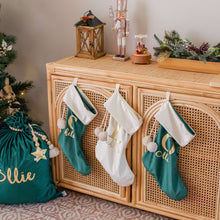 Load image into Gallery viewer, Green and white stockings hanging on a rattan cabinet in a lounge room next to a green santa sack and christmas tree