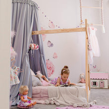 Load image into Gallery viewer, Grey round canopy over timber frame bed with girl lying on bed reading and rose decals on wall with toys around the room and pink accents