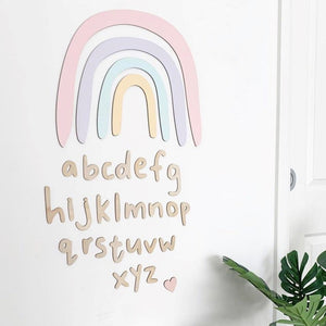 timber alphabet and wooden rainbow on white wall