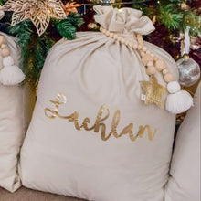 Load image into Gallery viewer, ivory santa sack personalised with the name lachlan in metallic gold font