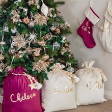 Load image into Gallery viewer, Purple and white personalised santa sacks and stockings sitting under a green christmas tree