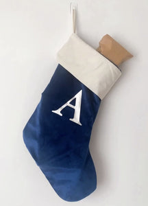 Navy blue velvet stocking personalised with the letter A in silver metallic font