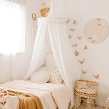 Load image into Gallery viewer, White round canopy over bed in girls boho room with butterfly decals and rattan doll bassinet