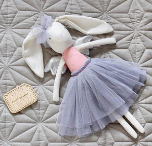 linen bunny laying on bed with grey tulle skirt and bow on head and silver wings